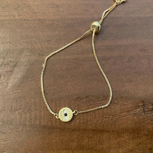 Gold chain bracelet with evil eye charm detail